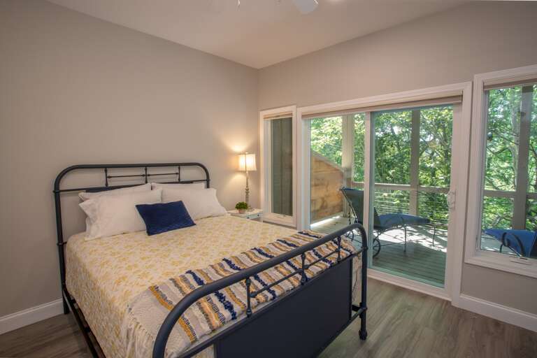 Queen bedroom on lower level with deck Queen bedroom on lower level with deck