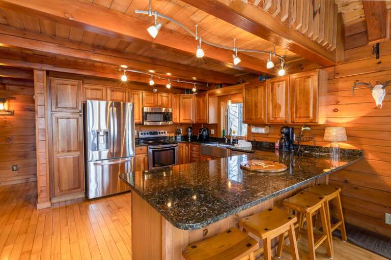 Kitchen boasts Updated Stainless Appliances and Counter-height Bar Stool seating!