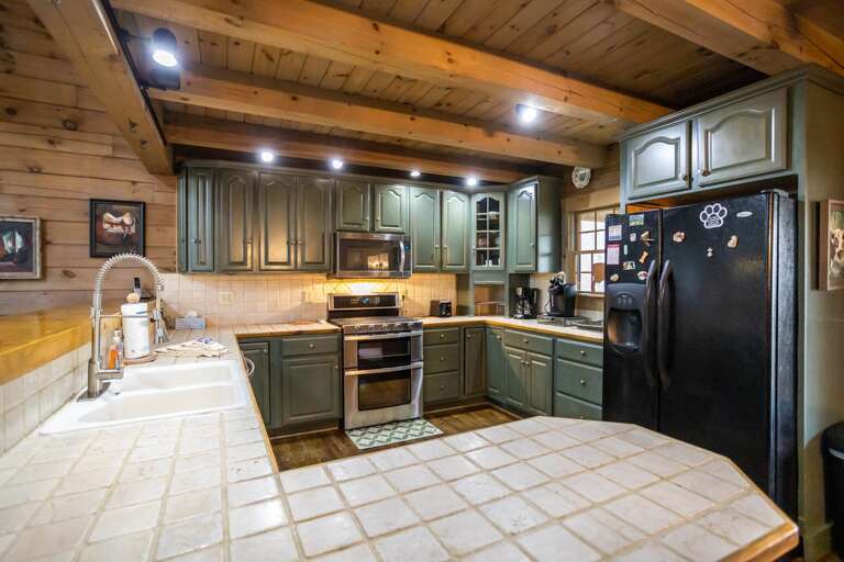 Large Kitchen with Tile Countertops and Lots of Lighting