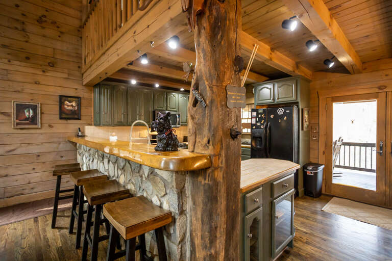 Real Log Beams and Stone Knee Wall with Wooden Bar Top