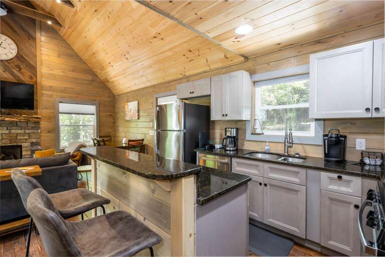 The Kitchen has Granite Countertops, Stainless Appliances and Island with Stools