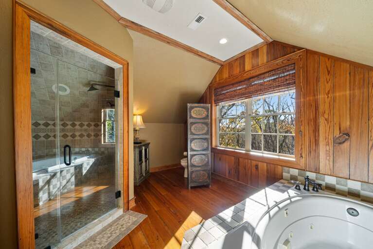 Jetted Soaking Tub with Large Tiled Step in Shower in the Master Suite