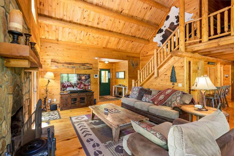 Living Room with Wood Burning Fireplace, TV and Comfortable Couches
