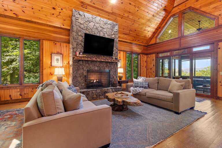 Stacked Stone Gas Fireplace and Mounted Flat Screen TV and Closed in Sunroom