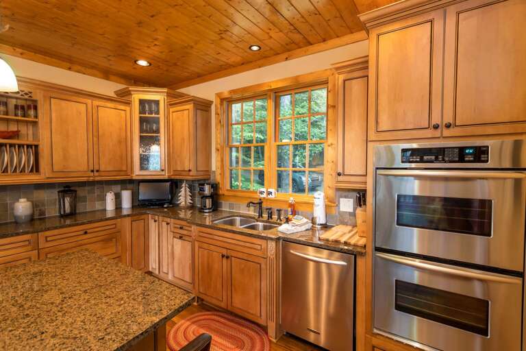 Double Stainless Stove and Appliances with Granite Countertops