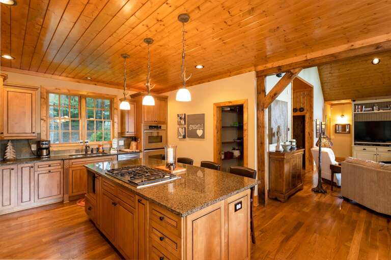 Stove Top In the Granite Kitchen Island with Bar Stools