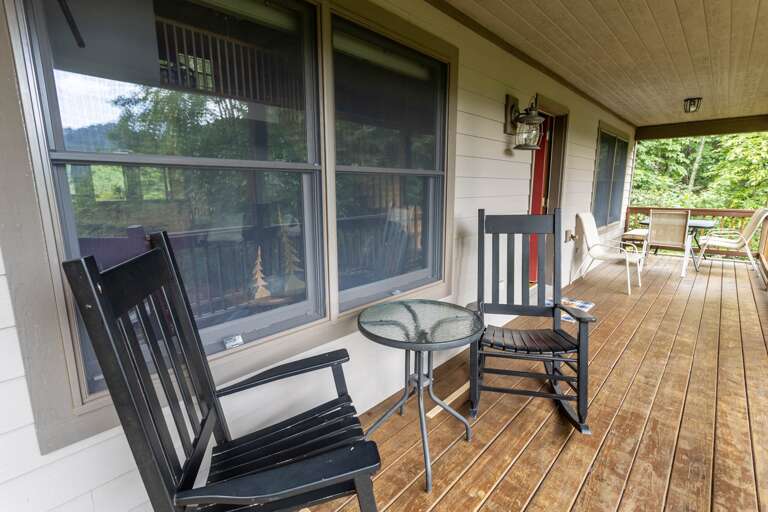 Deck with a Gas Grill, Quaint Table and Rocking Chairs Deck with a Gas Grill, Quaint Table and Rocking Chairs
