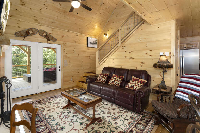 Living Room with Deck Access and Kitchen Behind