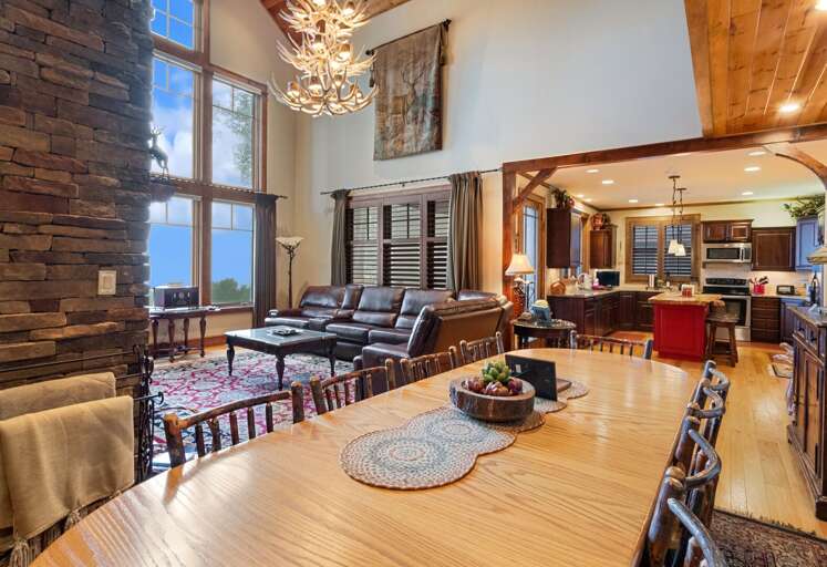 Dining Table Seats Ten with Stacked Stone Gas Fireplace in the Living Room
