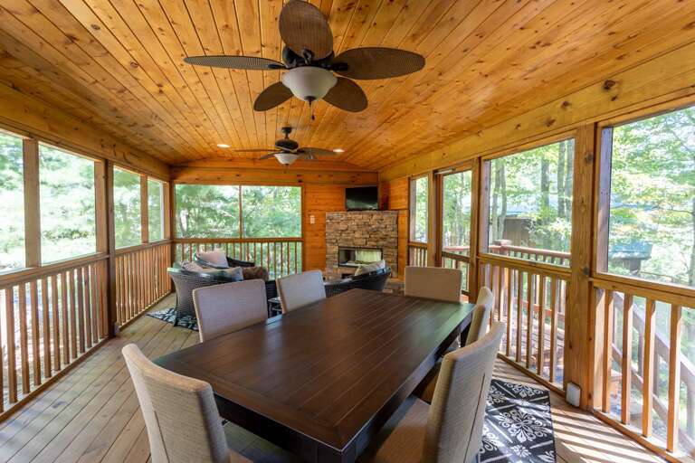 Fully Screened in Sun Room Porch with Gas Fireplace and Dining Table