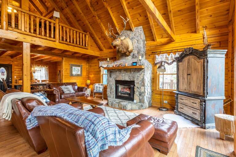 Leather Furniture Situated Around the Stacked Stone Gas Fireplace and TV