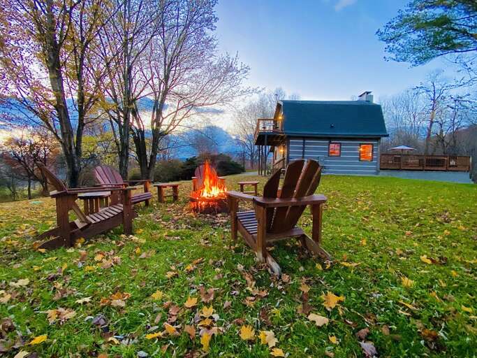 Fire Pit and Adirondack Chairs Near the Cabin in the Large Flat Yard