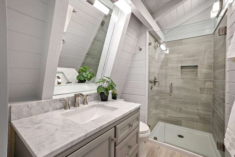 Light and Bright Bathroom with Custom Frameless Glass Door and Tile Shower