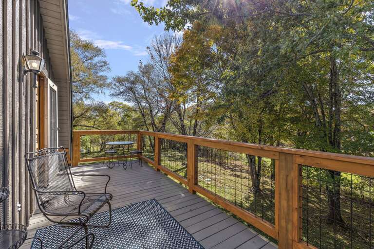 Upper Level Balcony with Rocker Style Chairs and Small Round Table