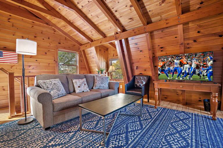Upstairs King Bedroom with Sofa and Large Screen TV