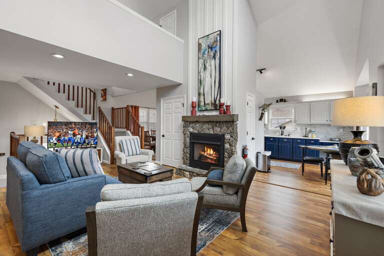 Main Floor Living Room Has a Gas Log Fireplace and Big Screen TV