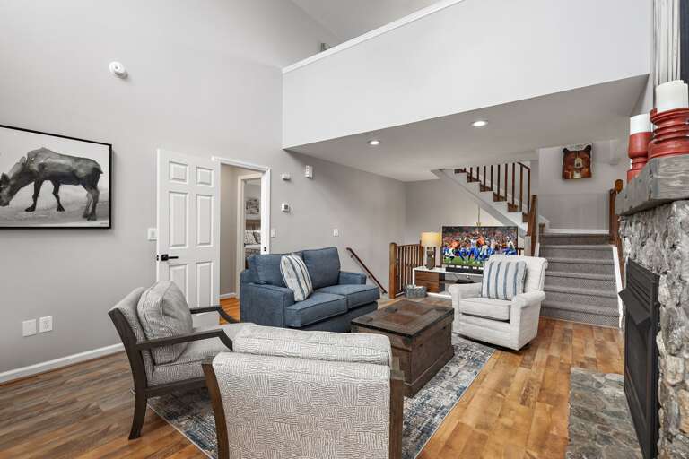 Main Floor Living Room with Stairs to the Upper and Lower Levels