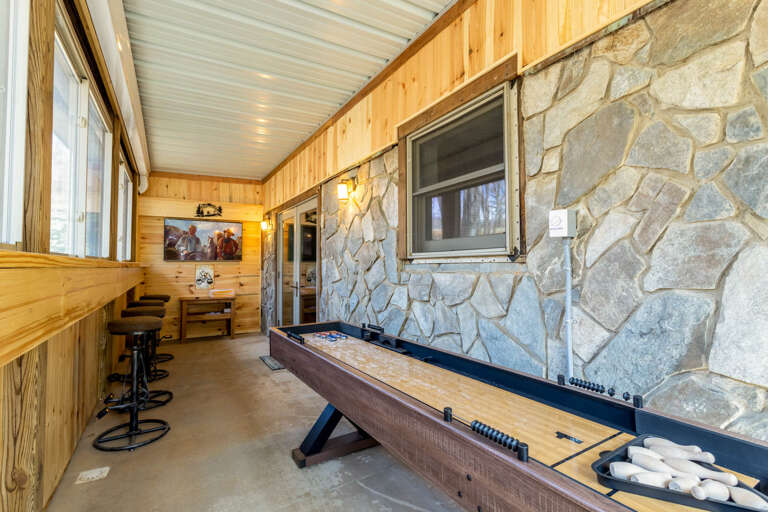 Enclosed Porch Game Room with Shuffleboard, Bar with Unique Bar Stools, and TV Enclosed Porch Game Room with Shuffleboard, Bar with Unique Bar Stools, and TV