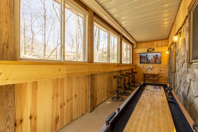 TV, Shuffleboard, and Unique Bar Looking Out the Wall of Windows TV, Shuffleboard, and Unique Bar Looking Out the Wall of Windows