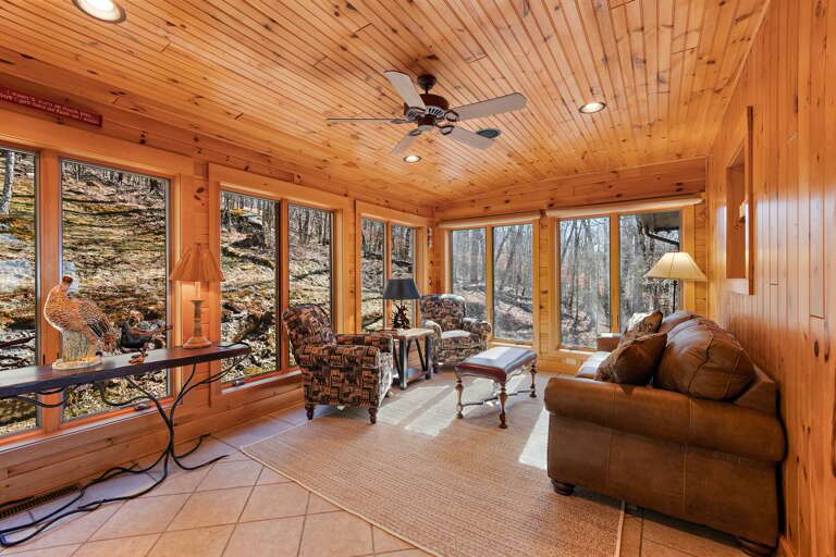 Comfortable Furniture in the Sun Room Surrounded by Windows