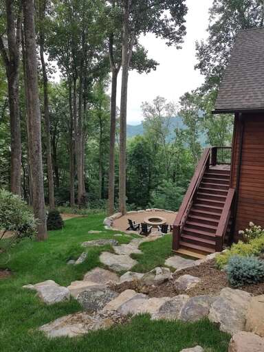 Wooden House With Stairs Surrounded By Trees And A Fire Pit Area Wooden House With Stairs Surrounded By Trees And A Fire Pit Area