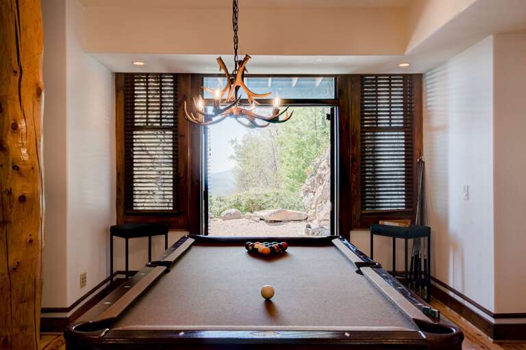 Billiard Table With French Doors Leading to the Back Yard