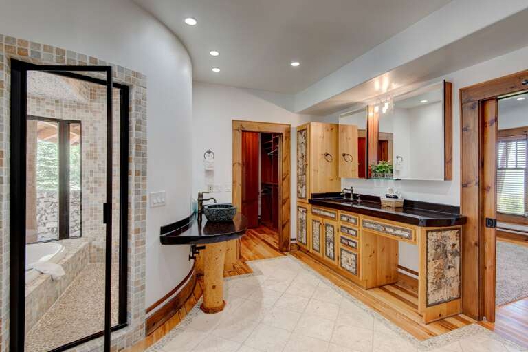 Expansive Master Bathroom with Walk-In Closet, Glass and Tile Tub and Shower, Steam Room, Separate Water Closet, and Double Vanities