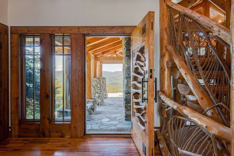 Main Floor Front Door with Expansive Flag Stone Patio Looking Over Long-Range Views