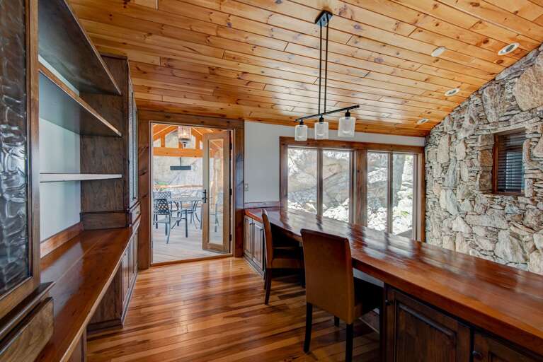 Office Work Space Off the Catwalk Overlooking the Main Floor Foyer, with a Balcony Attached Looking Down at the Waterfall Feature