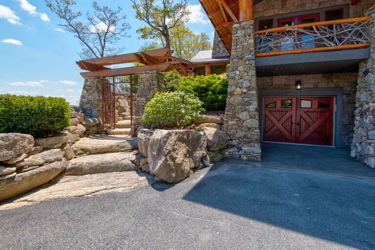 Paved Parking Area, Garage, and Stone Steps Leading to the Front Door