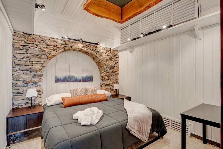 Sleeping Nook in the Lower Level With Arching Stacked Stone Feature