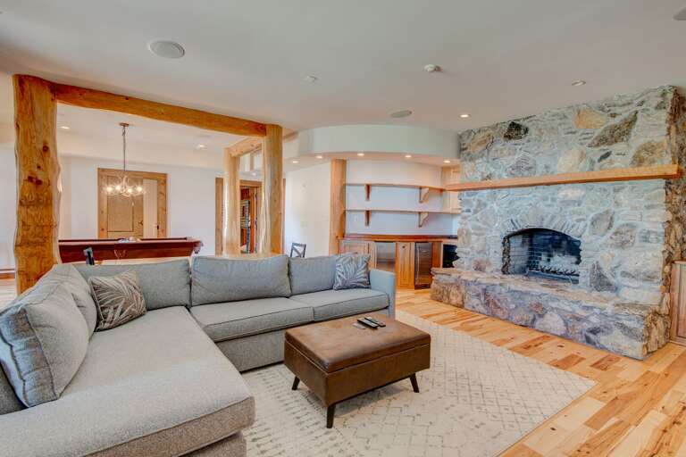 Stacked Stone Wood Burning Fireplace in the Family Room with a Mini Fridge and Comfy Sofa, Sofa Converts to a Queen and Twin Pull Out Bed