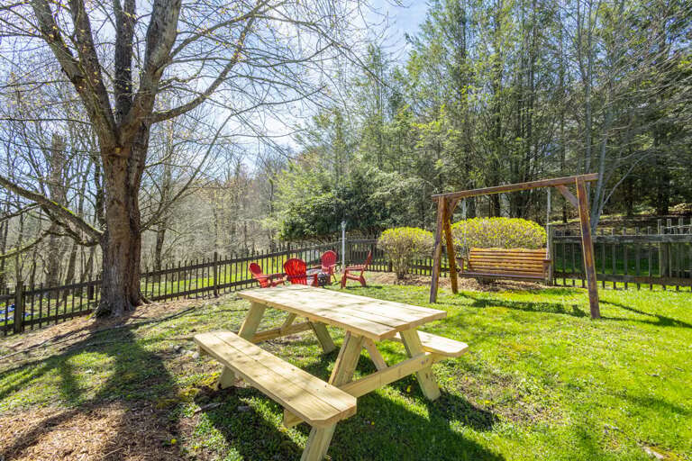 Fenced-In Yard with Picnic Table and Swing