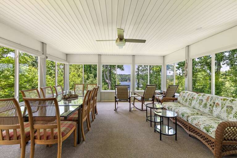 Sunroom with Large Dining Table, Couch and Rocking Chairs