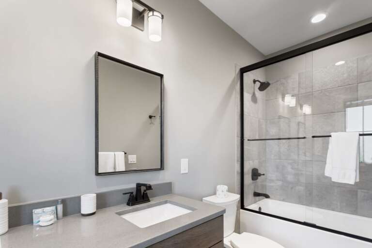 Private Ensuite Bathroom with Glass Enclosed Tub and Shower Combo Private Ensuite Bathroom with Glass Enclosed Tub and Shower Combo