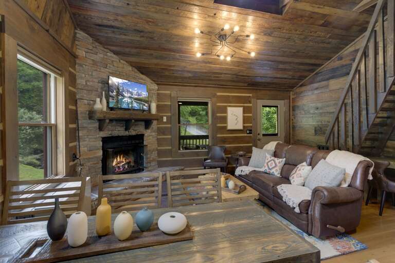 Gas Log Fireplace, TV and Warm Wood Interior with Upscale Mountain Decor at Eagle Ridge Creek