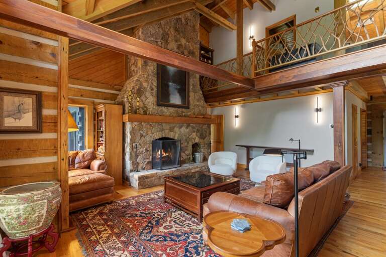 Living Room with Stone Wood-Burning Fireplace, Reading Nook, and Beautiful Wood Details
