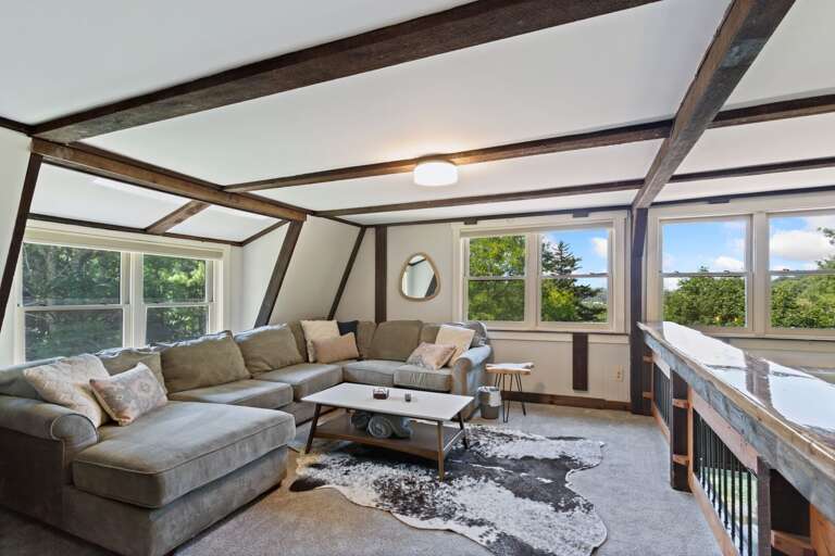 Loft with Large Sectional, Bright Natural Light and Custom Made Live Edge Bar Top Railing