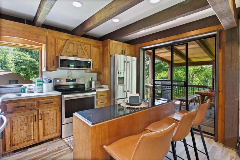 Stainless Appliances, Bar Seating and Glass Doors to the Main Level Deck