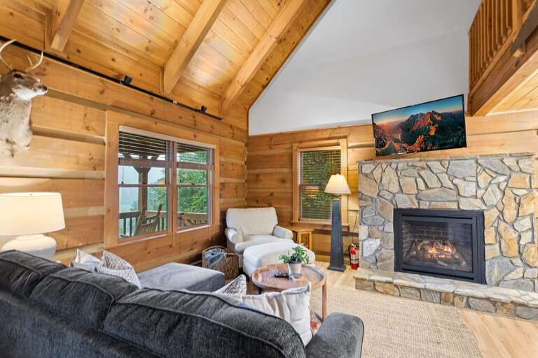 Gas Log Fireplace, Exposed Log Walls, and Vaulted Ceilings in the Living Room Gas Log Fireplace, Exposed Log Walls, and Vaulted Ceilings in the Living Room