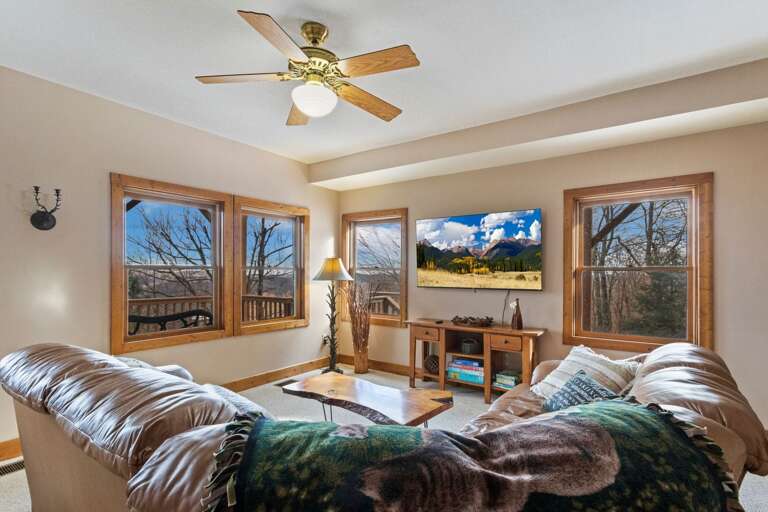 Family Room in the Lower Level with Mounted Big Screen TV and Deck