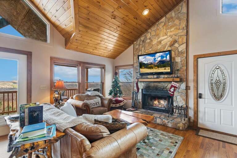 Vaulted Tongue-and-Groove Ceiling, Stacked Stone Wood Burning Fireplace and Leather Furniture