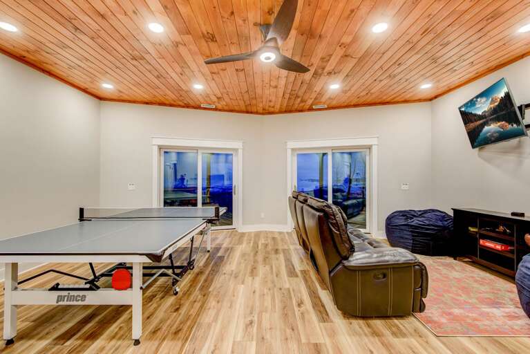 Lower Level Family Room with Ping Pong Table, TV with Theater Seats, Games and Sliding Glass Doors out to the Hot Tub Lower Level Family Room with Ping Pong Table, TV with Theater Seats, Games and Sliding Glass Doors out to the Hot Tub