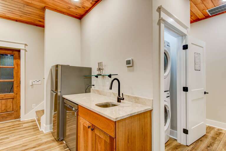 Mini Kitchen and Stacked Laundry Machines in the Lower Level Mini Kitchen and Stacked Laundry Machines in the Lower Level