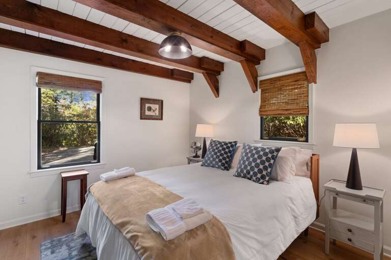 Main Floor Bedroom with Queen Bed, Tongue-and-Groove Ceilings and Custom Beams Main Floor Bedroom with Queen Bed, Tongue-and-Groove Ceilings and Custom Beams