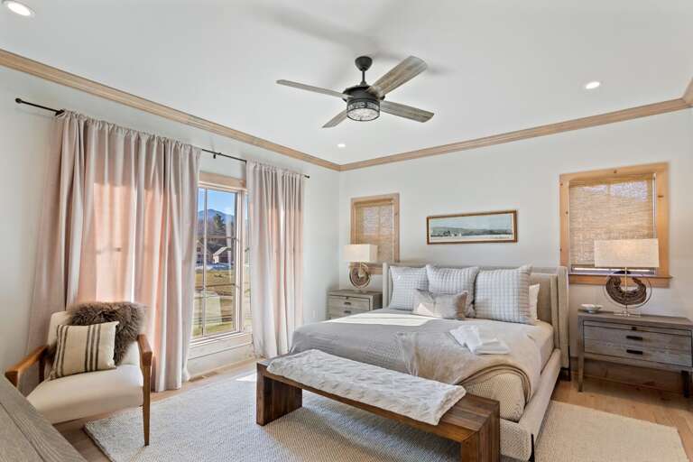 Main Floor Master Bedroom with King Bed, TV, and Private Ensuite