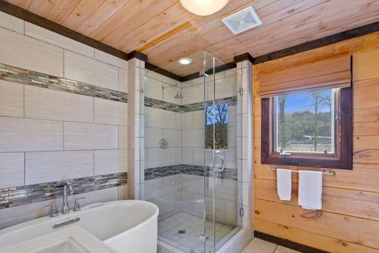 Main Level Bathroom with Tiled Glass Door Shower and Soaking Tub