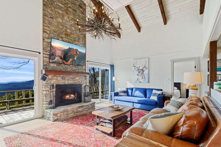 Wood-Burning Fireplace, Smart TV, and Glass Doors Letting in Natural Light