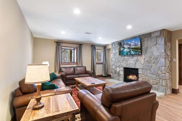 Lower Level Family Room with Leather Furniture TV and Gas Fireplace,