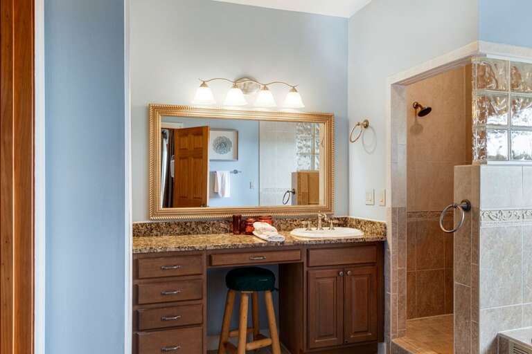 Large Tiled Step in Shower and Vanity with a Make-Up Stool in the Master Bathroom Large Tiled Step in Shower and Vanity with a Make-Up Stool in the Master Bathroom